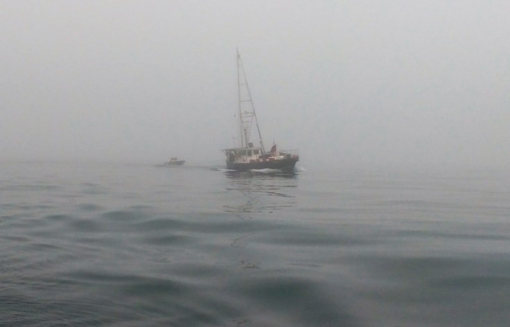Boat appears out of fog Ray Penson