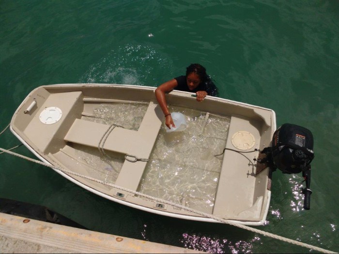 Jessica bailing a full boat load of water
