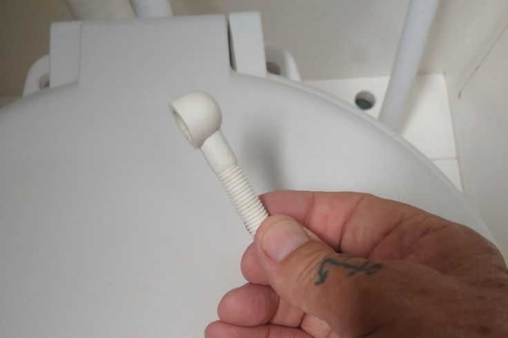 Lavac Toilet lid and seat hinge part. Photo Ray Penson