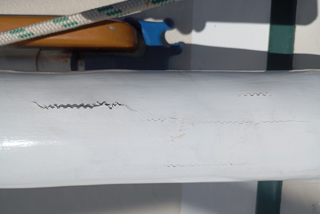 Spinnaker Pole, stress cracks showing in the carbon fiber. Photo Ray Penson
