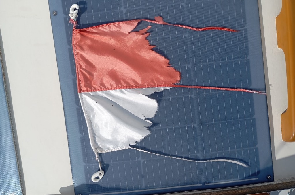 Indonesian flag, just about worn out, time to move on. Photo Ray Penson