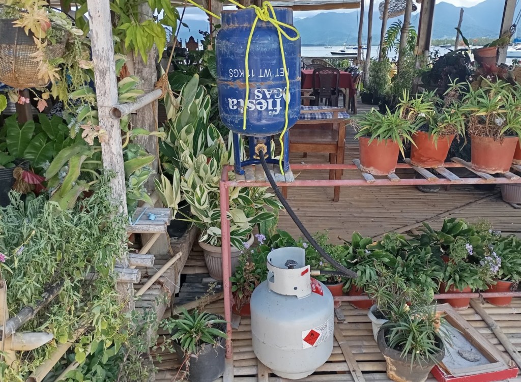 Decanting gas from Philippine bottle to NZ bottle at the Abanico yacht Club. Photo Ray Penson