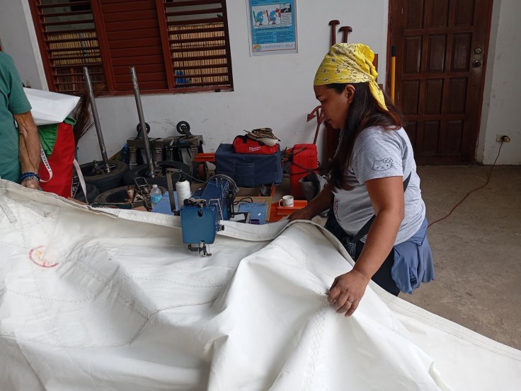 Long days of sail repairs. Photo Ray Penson